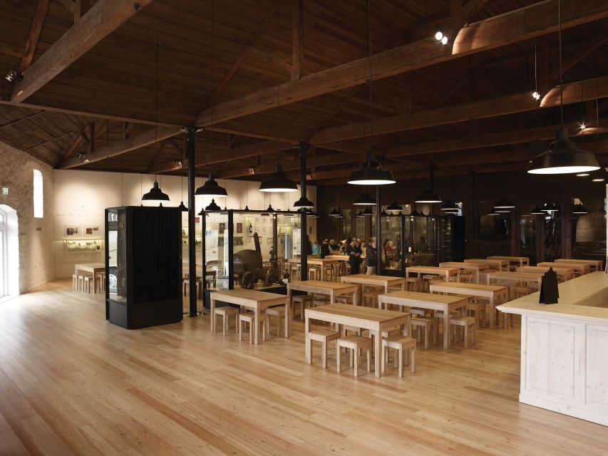 Porto: Graham's Port Lodge Tour with Premium Wine Tastings - Inside a cellar with 2,000 oak pipes