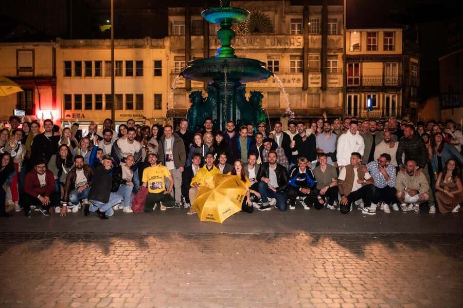 Porto: Pub Crawl with 7 Drinks, Games, and VIP Club Entry - Meeting the team at Fonte dos Leões